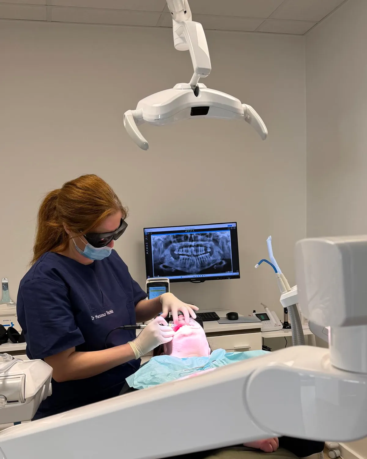 Dr Rachida Messous, dentist, treating a patient at Dentalplus in Luxembourg